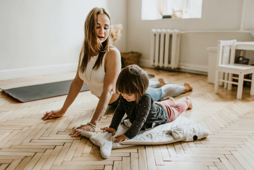 A mom practicing yoga as a mindfulness practice with her baby