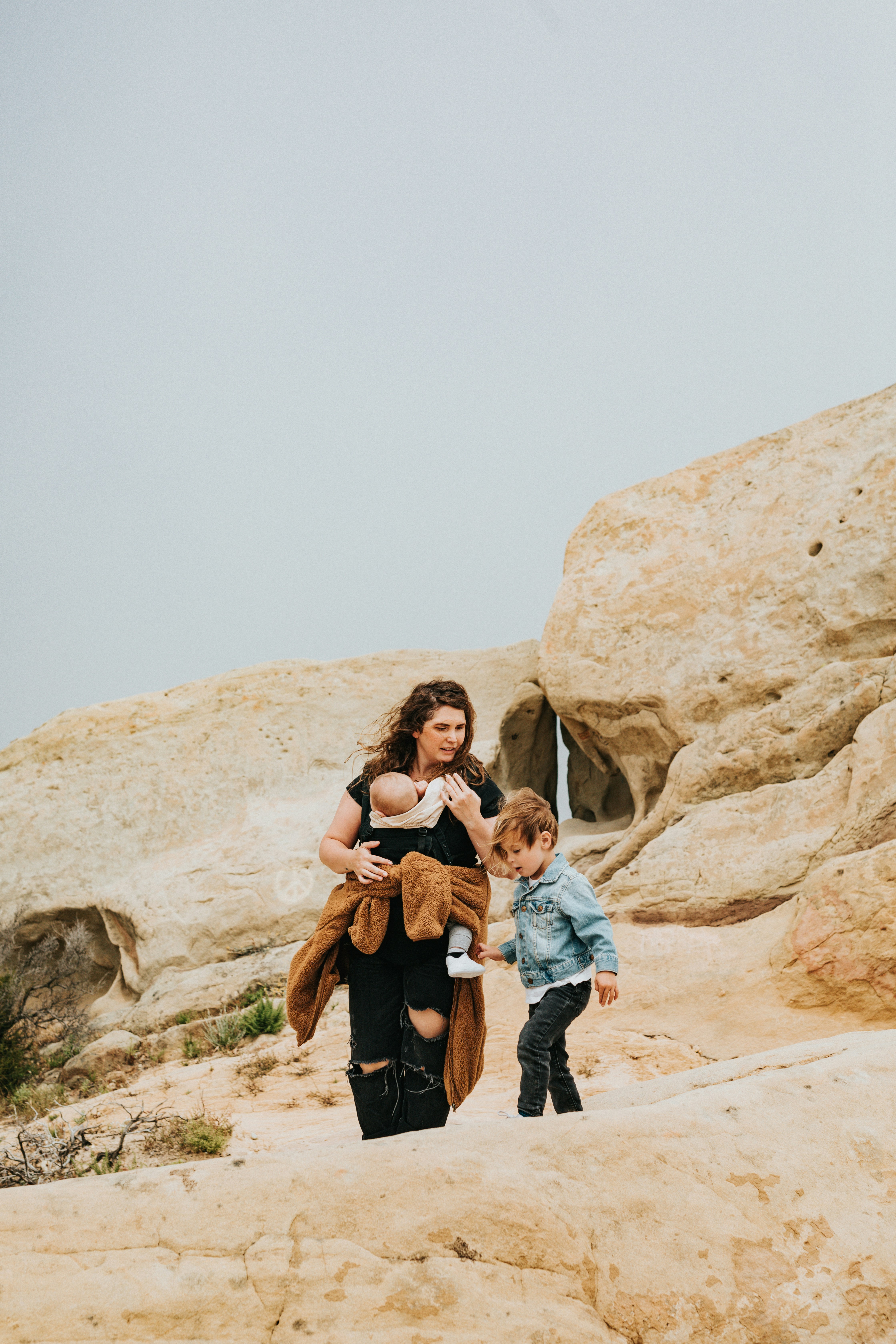 A mom with her kids in a pictoresque rocky landscape. Traveling with kids made easier