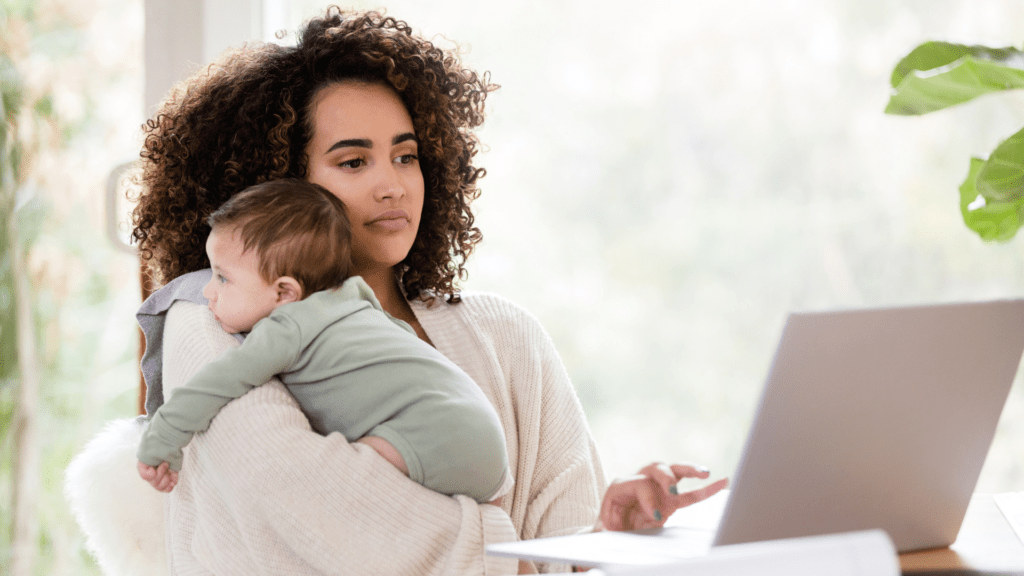 A busy mom working with child in her arm. Looking for Time Management Tips online.