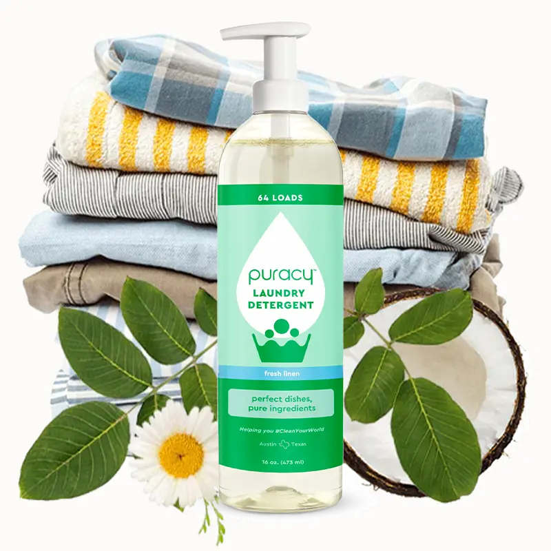 A bottle of puracy non toxic laundry detergent in front od a pile of clothes, a flower and leaves to illustrate the fresh scent